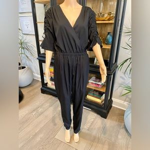 Bebe black v neck women’s jumpsuit M